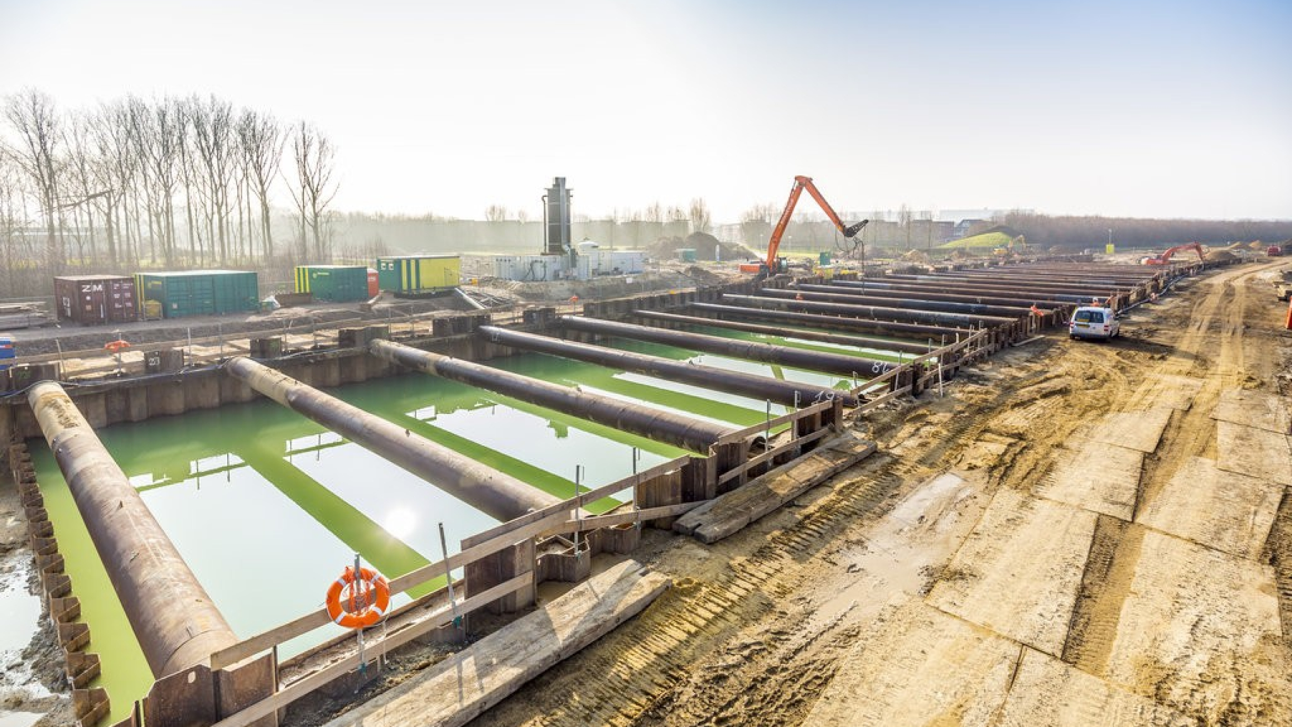 Grote bakken met water bij werkzaamheden van de nieuwe ongelijkvloerse kruising N276