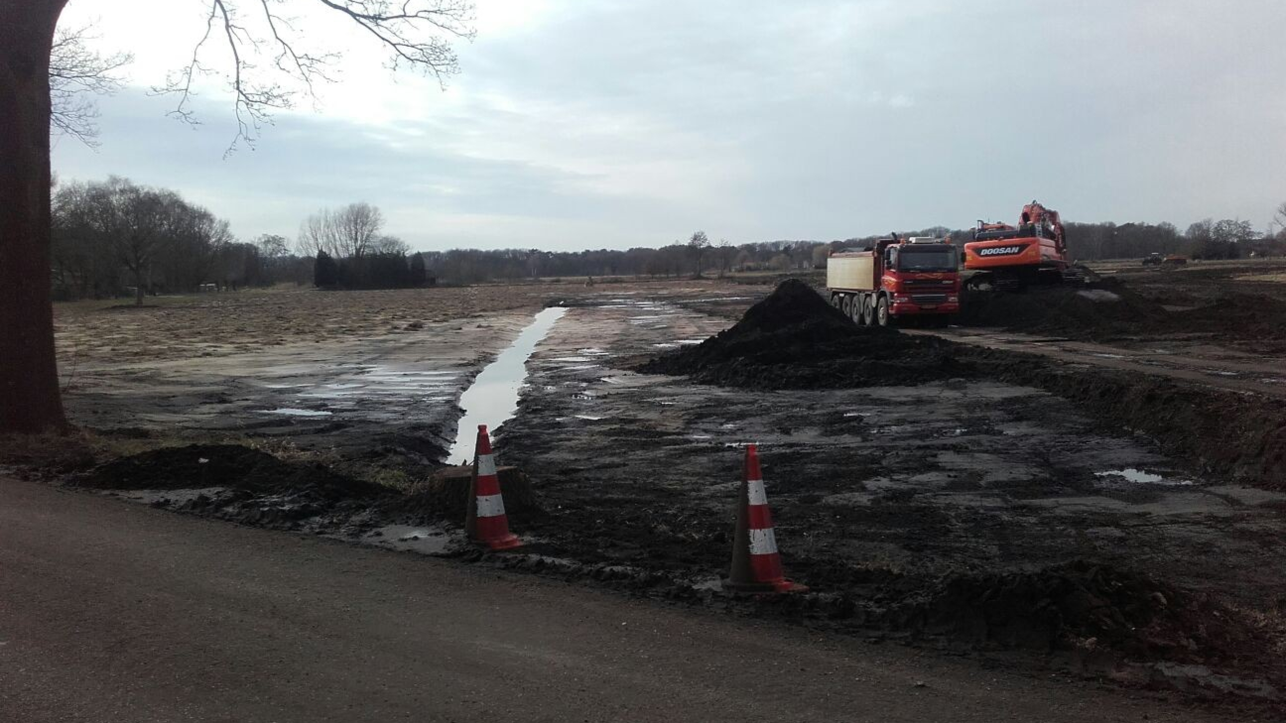 Kraan en vrachtwagen staan in het zand bij het project Natuurontwikkeling Sint Annabos te Uden