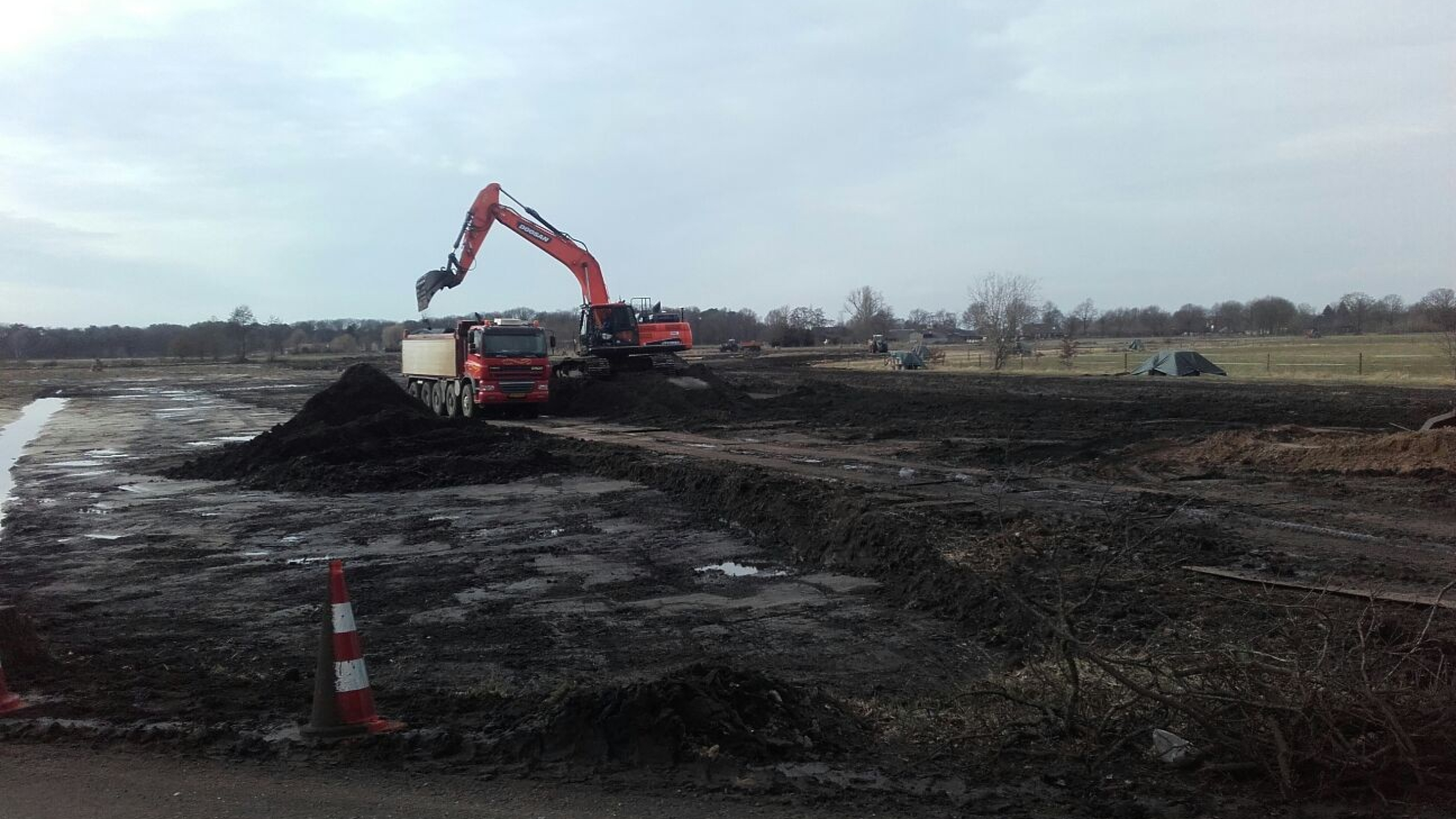 Kraan en vrachtwagen staan in het zand bij het project Natuurontwikkeling Sint Annabos te Uden