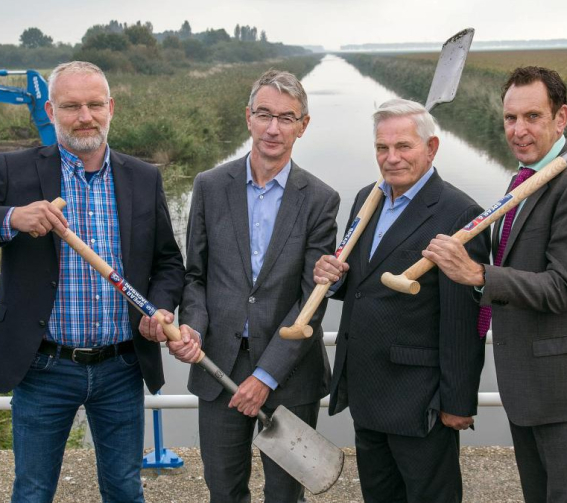 directeur Teun Stoop van aannemer Ploegam neemt symbolisch een spade in ontvangst van Martin Jansen (Het Flevo-Landschap), Ton Leijten (heemraad Waterschap Zuiderzeeland) en Jaap Lodders (gedeputeerde provincie Flevoland).  