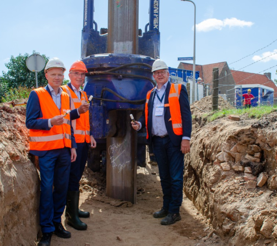 Breun Breunissen, Eric Withaar en Gijs Ploegmakers (namens Dijkzone Alliantie Stenendijk) zetten hun  handtekening op een 12 meter lange damwand die wordt gebruikt voor het versterken van de Stenendijk in Hasselt. 
